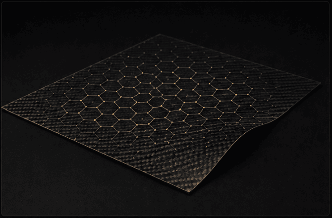 Flexible woven carbon fiber sheet with a glowing golden hexagonal lattice pattern